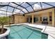 Inviting screened-in pool area with a sparkling pool, spacious deck, and covered patio at 1542 Ormond Ter, Parrish, FL 34219