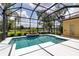 Beautiful in-ground pool is surrounded by a screened enclosure with lush landscaping and serene water views at 1542 Ormond Ter, Parrish, FL 34219