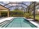 Inviting screened-in pool offers a relaxing oasis with its sparkling water and well-maintained surroundings at 1542 Ormond Ter, Parrish, FL 34219