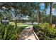 Scenic walking trail with lush landscaping and serene lake views, perfect for an evening stroll at 1542 Ormond Ter, Parrish, FL 34219