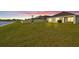 Expansive backyard features lush green grass, privacy fence, and lovely view, perfect for outdoor activities and relaxation at 16746 Parker River St, Wimauma, FL 33598