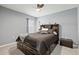 Cozy bedroom with a queen-sized bed, built-in headboard storage, and soft lighting at 16746 Parker River St, Wimauma, FL 33598