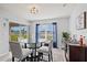 Cozy dining area with glass table, comfortable seating, and view of outdoor scenery at 16746 Parker River St, Wimauma, FL 33598