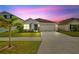 Charming single-story home featuring a well-manicured lawn and two-car garage at 16746 Parker River St, Wimauma, FL 33598