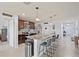 Modern kitchen with stainless steel appliances, granite countertops, and center island with bar seating at 16746 Parker River St, Wimauma, FL 33598