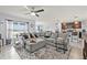 Spacious open-concept living area with neutral tones and ample natural light at 16746 Parker River St, Wimauma, FL 33598