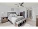 Comfortable main bedroom with neutral decor, ceiling fan, and ample closet space at 16746 Parker River St, Wimauma, FL 33598