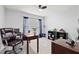 Home office space with a comfortable chair, functional desks, and ample natural light at 16746 Parker River St, Wimauma, FL 33598