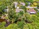 The property features a serene waterfront with mature trees, providing privacy and a connection to nature at 1715 Fossil Dr, Englewood, FL 34223
