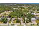 Aerial view of a neighborhood surrounded by lush greenery and waterways at 1715 Fossil Dr, Englewood, FL 34223