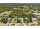 Bird's-eye view of the property highlighting its location amidst lush greenery and surrounding neighborhood at 1715 Fossil Dr, Englewood, FL 34223