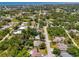 Aerial view of the home in a lush, green neighborhood with water views and a tranquil setting at 1715 Fossil Dr, Englewood, FL 34223