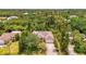 Expansive aerial shot showcasing the neighborhood surrounded by mature trees and green spaces at 1715 Fossil Dr, Englewood, FL 34223