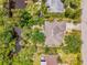 Lush landscaping surrounds this home next to the river with a dock and a spacious driveway at 1715 Fossil Dr, Englewood, FL 34223