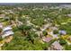 The aerial view captures the property surrounded by lush landscaping in a charming residential neighborhood at 1715 Fossil Dr, Englewood, FL 34223