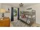 Coastal bedroom features a bunk bed with nautical decor and a window overlooking the outside at 1715 Fossil Dr, Englewood, FL 34223