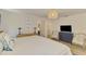 Bright bedroom with a double bed, hardwood floors, and views to the bathroom, closet, and hall at 1715 Fossil Dr, Englewood, FL 34223