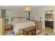 Bright, spacious bedroom featuring natural wood furniture and a view to the exterior through curtained windows at 1715 Fossil Dr, Englewood, FL 34223