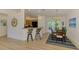Bright dining area with modern lighting, a table for six, and easy access to the outdoors at 1715 Fossil Dr, Englewood, FL 34223