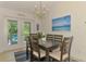 Dining room with a modern chandelier, table with six chairs, and stylish accents at 1715 Fossil Dr, Englewood, FL 34223