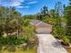 Charming single-Gathering home with a two-car garage surrounded by mature landscaping and a concrete driveway at 1715 Fossil Dr, Englewood, FL 34223