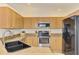 Bright kitchen with ample wood cabinetry, stainless steel appliances, and sleek countertops at 1715 Fossil Dr, Englewood, FL 34223