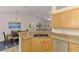 Open-concept kitchen with dining area and stainless steel dishwasher and sink at 1715 Fossil Dr, Englewood, FL 34223