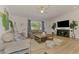 Cozy living room featuring comfortable seating, a TV, and modern décor at 1715 Fossil Dr, Englewood, FL 34223