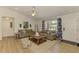 Bright living room with modern décor, wood floors, comfortable seating, and natural light at 1715 Fossil Dr, Englewood, FL 34223