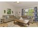 Inviting living room with comfortable seating, stylish décor, and a large window at 1715 Fossil Dr, Englewood, FL 34223