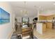 Open-concept design with a dining table under a modern chandelier and living area with plentiful natural light at 1715 Fossil Dr, Englewood, FL 34223