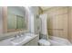 Bright bathroom with a granite countertop, tub, and ample storage at 203 28Th W St, Palmetto, FL 34221