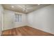 Well-lit bedroom showcasing beautiful wood floors, a window with blinds, and a neutral color palette at 203 28Th W St, Palmetto, FL 34221