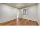 Cozy bedroom with wood floors, a window with blinds, and a connecting door at 203 28Th W St, Palmetto, FL 34221