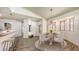 Inviting dining area featuring wood look floors, stylish lighting and adjacent to the kitchen at 203 28Th W St, Palmetto, FL 34221