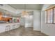 Open dining area with stylish light fixture, open view of the kitchen and wood look floors at 203 28Th W St, Palmetto, FL 34221