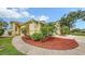 Charming home featuring a well-manicured lawn, lovely landscaping and a walkway to the front door at 203 28Th W St, Palmetto, FL 34221