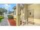 Inviting front porch area with a rocking chair and a landscaped walkway at 203 28Th W St, Palmetto, FL 34221