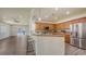 Open-concept kitchen with wood cabinets, bar seating, and stainless steel appliances at 203 28Th W St, Palmetto, FL 34221