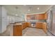 Open kitchen features wood cabinets, stone counters, stainless appliances, and a breakfast bar at 203 28Th W St, Palmetto, FL 34221