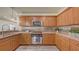 A close up of a well-appointed kitchen showcasing wood cabinets and stainless steel appliances at 203 28Th W St, Palmetto, FL 34221