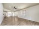 Spacious living room featuring luxury vinyl flooring, a ceiling fan, and plenty of natural light at 203 28Th W St, Palmetto, FL 34221