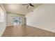 Inviting living room with luxury vinyl flooring, a ceiling fan, and a sliding door to the lanai at 203 28Th W St, Palmetto, FL 34221