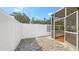 Enclosed patio with screened in room, paved flooring and tall privacy fence for outdoor enjoyment at 203 28Th W St, Palmetto, FL 34221