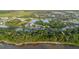 Aerial view of a community with a lake and homes surrounded by lush green trees at 20316 Natures Corner Dr, Tampa, FL 33647