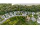 Aerial view of a property in a residential area near a lake and surrounded by trees at 20316 Natures Corner Dr, Tampa, FL 33647