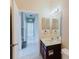 Bright bathroom featuring a single sink vanity and tile flooring at 20316 Natures Corner Dr, Tampa, FL 33647