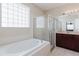 Bright bathroom with soaking tub, tiled shower, and vanity with storage at 20316 Natures Corner Dr, Tampa, FL 33647