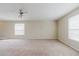 Spacious carpeted bedroom with ceiling fan and natural light at 20316 Natures Corner Dr, Tampa, FL 33647