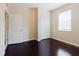 Bedroom with dark wood floors, window with blinds, and a closet at 20316 Natures Corner Dr, Tampa, FL 33647